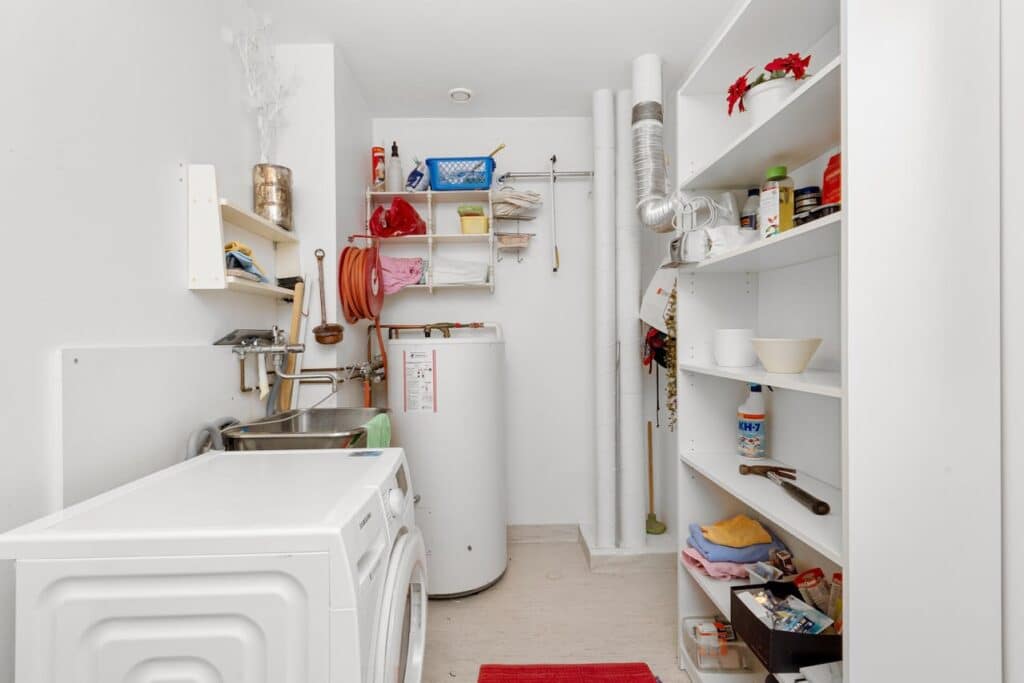 Water heater installed inside of laundry room.