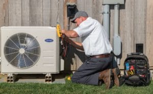 HVAC technician servicing outdoor unit