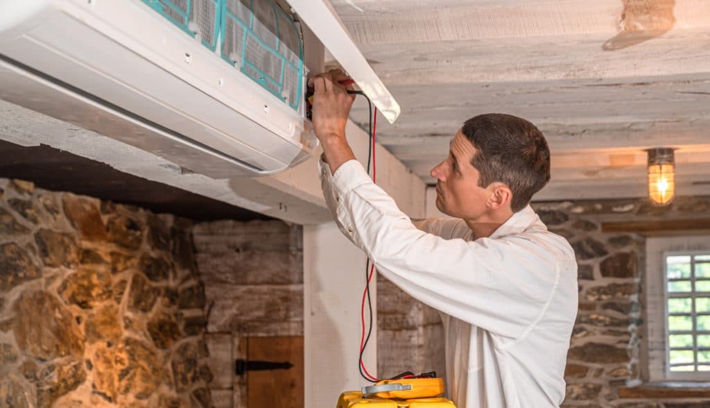 HVAC technician installing ductless system