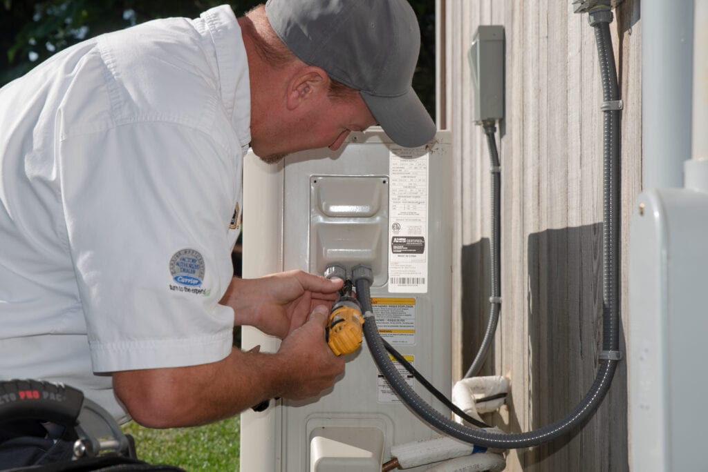 Carrier system receiving maintenance from an RSC Heating and Air Conditioning Technician