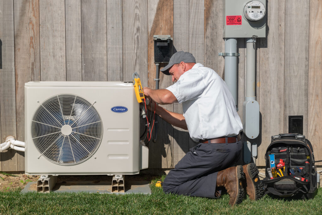 RSC HVAC Technician performing routine maintenance on Carrier HVAC systems.