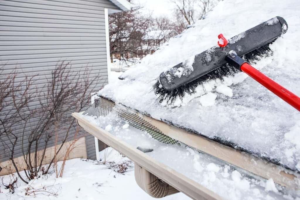 home winterization chore cleaning gutters to avoid ice dams.