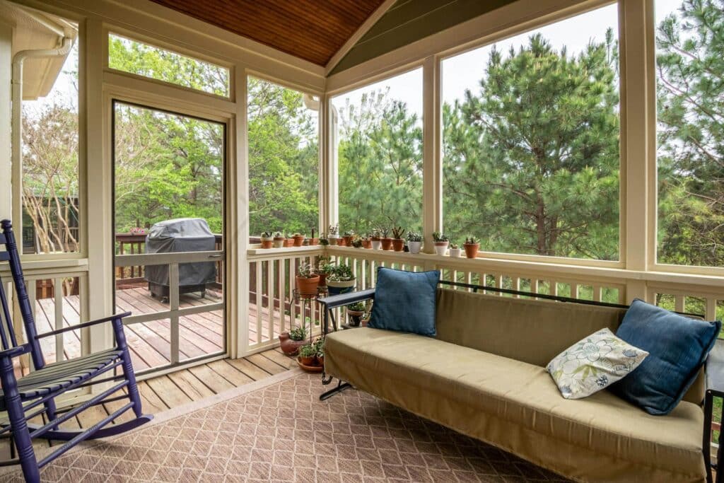 screened in porch couch swing and rocking chair.