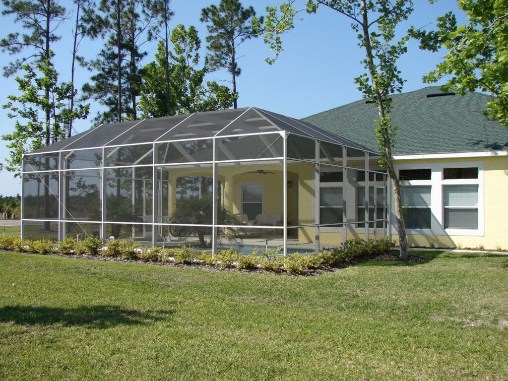 screen in porch with a pool and awning.