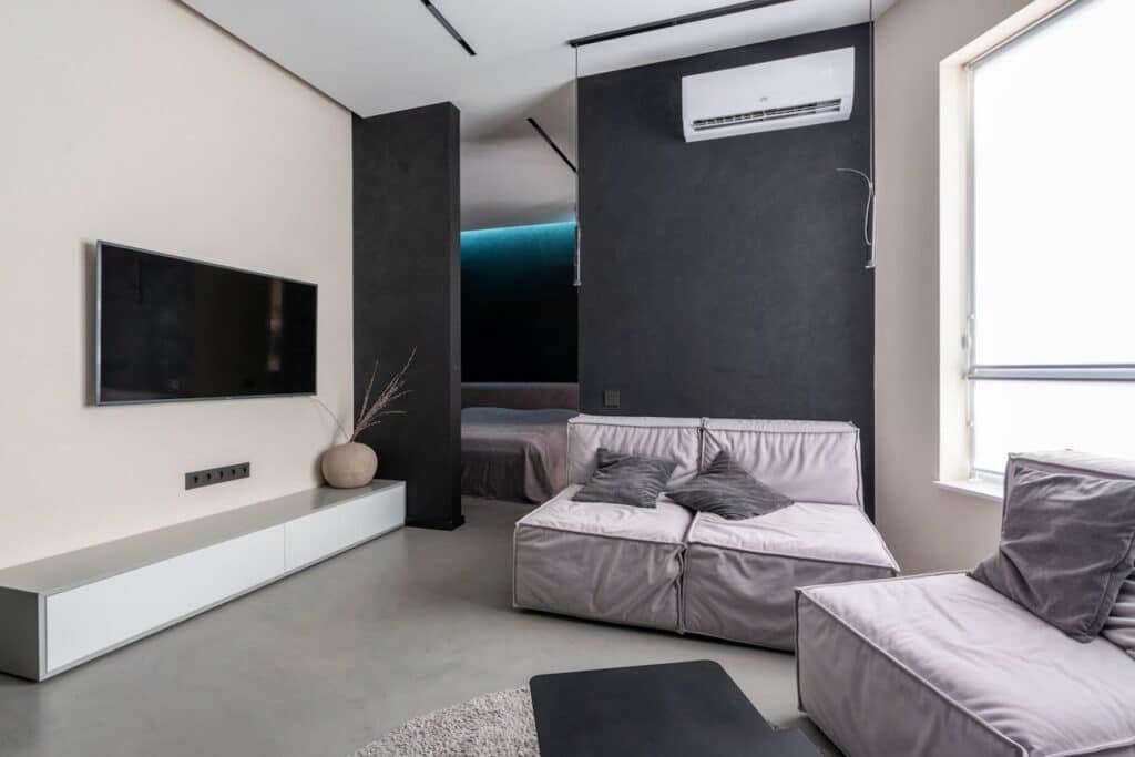 Ceiling mounted mini split system in modern apartment living room.